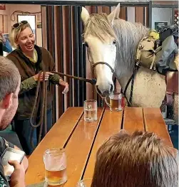  ??  ?? Larissa Mueller and her horse Sprite enjoy a cold one while on their charity ride, which has spanned an adventure-filled 15 months.