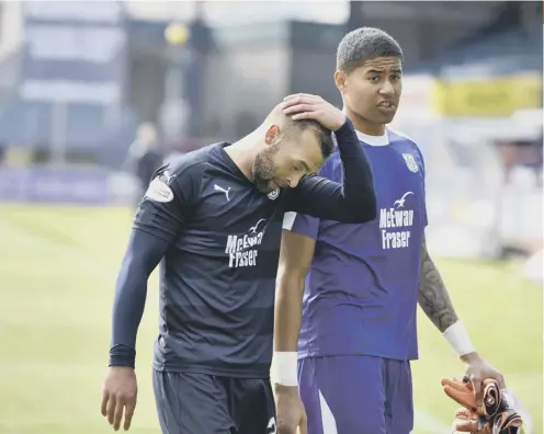  ??  ?? 2 Dundee duo James Horsfield, left, and Seny Dieng trudge off the field at Dens Park after defeat by Hamilton confirmed their relegation.