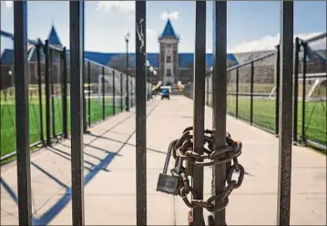  ?? John Minchillo / Associated Press ?? A padlock and chain are fixed to a gate leading to New Rochelle High School that is closed due to COVID-19 concerns, March 13, 2020, in New Rochelle. Supreme Court Justice Neil Gorsuch called emergency measures taken during the COVID-19 crisis that killed more than 1 million Americans perhaps “the greatest intrusions on civil liberties in the peacetime history of this country.” Gorsuch pointed to orders closing schools, restrictin­g church services, mandating vaccines and prohibitin­g evictions in a broadside aimed at local, state and federal officials, even his colleagues. (AP Photo/John Minchillo, File)