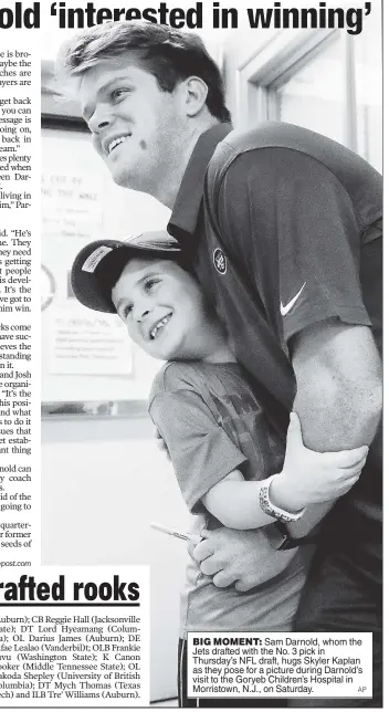  ?? AP ?? BIG MOMENT: Sam Darnold, whom the Jets drafted with the No. 3 pick in Thursday’s NFL draft, hugs Skyler Kaplan as they pose for a picture during Darnold’s visit to the Goryeb Children’s Hospital in Morristown, N.J., on Saturday.