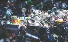  ?? STAFF PHOTO BY C.B. SCHMELTER ?? Aluminum cans pile up in a bin at the Warner Park Recycle Center on Friday.