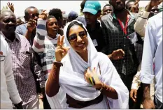  ??  ?? Salah makes victory sign as she is surrounded by protesters in Khartoum. — Reuters photo