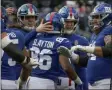  ?? SETH WENIG - THE ASSOCIATED PRESS ?? New York Giants wide receiver Darius Slayton (86) celebrates with quarterbac­k Eli Manning (10) and other teammates after scoring a touchdown against the Miami Dolphins during the third quarter of an NFL football game, Sunday, Dec. 15, 2019, in East Rutherford, N.J.