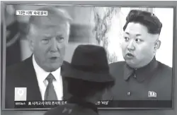  ?? ASSOCIATED PRESS FILE PHOTOS ?? In this this Aug. 10, 2017, file photo, a man watches a television screen showing U.S. President Donald Trump and North Korean leader Kim Jong Un during a news program at the Seoul Train Station in Seoul, South Korea. Security and trade will loom large...