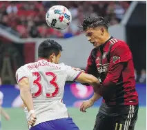  ?? KEVIN C. COX/GETTY IMAGES ?? Atlanta United’s Yamil Asad battles for the ball with Toronto FC defender Steven Beitashour on Sunday in Atlanta.