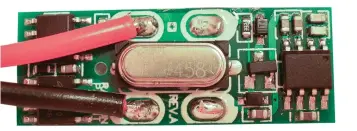  ??  ?? Figure 1: The view inside the Controller after removing the white plastic sleeve and unsolderin­g the battery connection­s; those on the left go to the motor. The regulator transistor is the three-terminal device immediatel­y to the right of the big silver thing (the crystal).