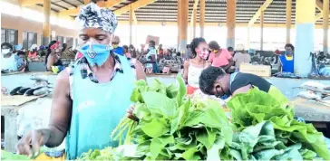  ?? PHOTOGRAPH COURTESY OF UN ?? TRADERS at this market in Luanda, Angola have adopted measures to keep themselves safe during the pandemic.