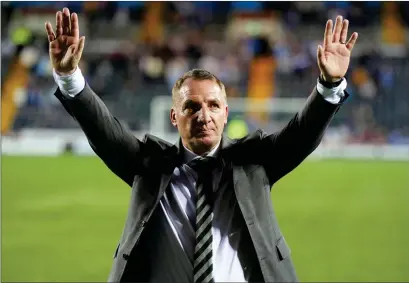  ?? ?? Celtic manager Brendan Rodgers celebrates with the visiting support at Rugby Park on Wednesday night