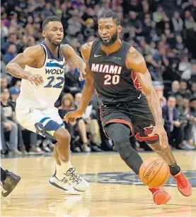  ?? HANNAH FOSLIEN/GETTY ?? Miami’s Justise Winslow drives to the basket against Minnesota’s Andrew Wiggins during the second quarter of the home opener in Minneapoli­s, Minnesota.