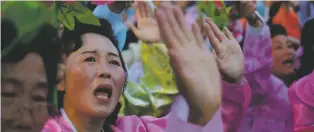  ?? ASSOCIATED PRESS FILE PHOTO ?? North Koreans wave decorative flowers as they walk past their leader, Kim Jong Un, during a parade in Pyongyang in 2015.