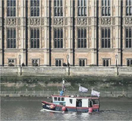  ?? PICTURE: GETTY ?? 0 Nigel Farage and Fishing for Leave supporters pass the Houses of Parliament this week