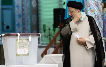  ?? (Majid Asgaripour/WANA/via Reuters) ?? EBRAHIM RAISI arrives at a polling station in Tehran to cast his vote in last week’s presidenti­al election, which he won.