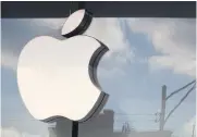  ?? AFP ?? The Apple company logo hangs above an Apple retail store in Chicago, Illinois.