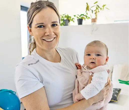  ?? ?? Golden moments: Hannah Mills at home with daughter Sienna, and (below, left) with Saskia Clark after winning at the 2016 Rio Olympics