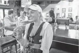  ?? JIM RASSOL/STAFF PHOTOGRAPH­ER ?? Nicole Indell, who recently moved to downtown Fort Lauderdale, enjoys a beer with family and friends at American Social on Las Olas Boulevard.