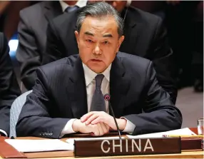  ?? (Reuters) ?? CHINA’S FOREIGN Minister Wang Yi listens to US President Donald Trump address a UN Security Council meeting during the 73rd session of the United Nations General Assembly at UN headquarte­rs in New York, in late September.