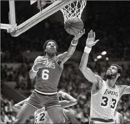  ?? PHOTOS BY AP ?? The 76ers’ Julius Erving goes up to score as the Lakers’ Kareem Abdul-Jabbar defends May 14, 1980, during Game 5. Abdul-Jabbar scored 40 points in the win but would leave the game with an ankle injury that kept him from Game 6.