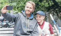  ?? Photo: KEVIN STENT/FAIRFAX NZ ?? Reason to smile: Black Caps batsman Kane Williamson poses for a selfie with junior Wellington cricketer Aston Burwell-Garrett, 7. It was the icing on the cake for the youngster, after his Eastern Suburbs club was presented with $5000 of new cricket...