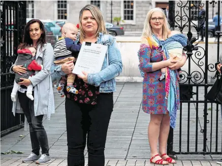  ?? PHOTO: PA ?? Taking a stand: Mothers (from left) Andrea Simic, Tara MacDarby, Paula Solan, Amy McGivney, and their babies, at Leinster House where they presented a petition calling for an extension of maternity leave for three months due to the Covid-19 crisis.