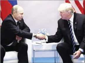  ?? SAUL LOEB/AFP ?? US President Donald Trump (right) and Russia’s President Vladimir Putin shake hands during a meeting at the G20 Summit in Hamburg on Friday.