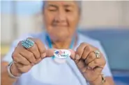  ?? AP PHOTO/CAYLA NIMMO ?? Mildred James of Sanders, Ariz., shows off her “I Voted” sticker as she awaits election results in Window Rock on the Navajo Nation in 2018.
