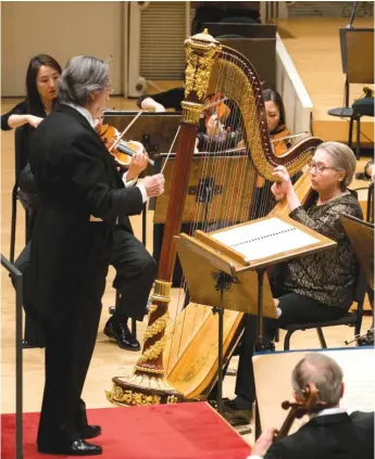  ??  ?? Riccardo Muti conducts harp soloist Sarah Bullen and the Chicago Symphony Orchestra in concert at Symphony Center. TODD ROSENBERG PHOTOGRAPH­Y