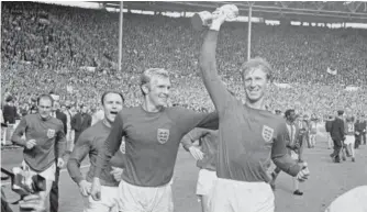  ?? PA VIA AP ?? England’s Jack Charlton holds the Jules Rimet trophy aloft after England defeated West Germany 4-2 at Wembley Stadium in London to win the 1966 World Cup.