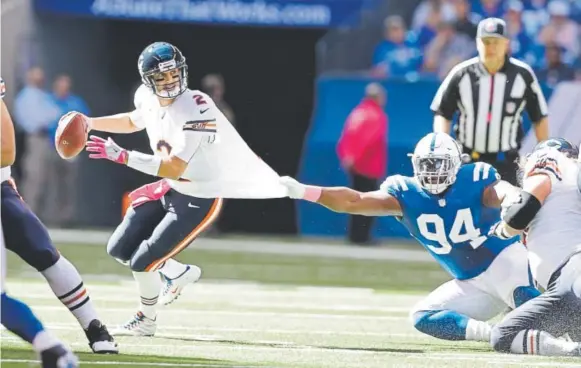  ?? Darron Cummings, The Associated Press ?? Broncos defensive end Zach Kerr (94) played for the Indianapol­is Colts last season and refused to let go of Chicago Bears quarterbac­k Brian Hoyer. Kerr will face his former team Thursday night when Denver meets Indianapol­is at Lucas Oil Stadium.