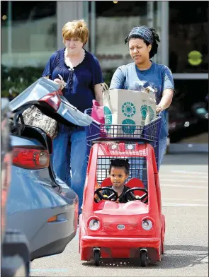  ?? AP/ROGELIO V. SOLIS ?? Whole Foods customers leave a store in Jackson, Miss., on Friday. Amazon plans to buy Whole Foods in a $13.7 billion deal that would give the online retailer access to more than 460 grocery stores worldwide.