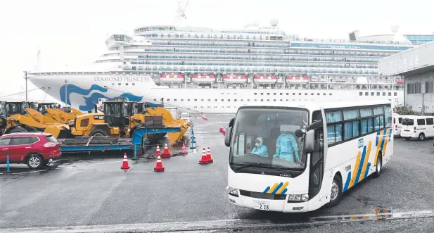  ?? Picture: AFP ?? JAPANESE QUARANTINE: A bus departs from the dockside next to the
Diamond Princess in Yokohama yesterday.