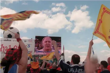  ?? Photograph:Tom Honan/Empics Sport ?? Scotland fans cheer Craig Brown on a big screen in Bordeaux at the 1998 World Cup.