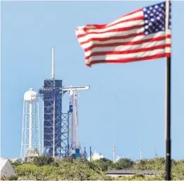  ?? JOE BURBANK/ORLANDO SENTINEL ?? In this view from the press site 3 miles from Launch pad 39-A, the SpaceX Falcon 9 carrying the Crew Dragon capsule is readied for launch at Kennedy Space Center Friday.