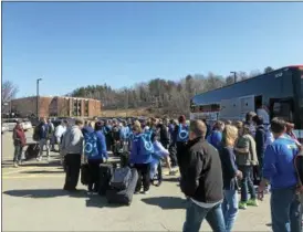  ?? LINDSAY MORAN — FOR THE RECORD ?? Columbia High School students gather Friday morning in a school parking lot with family and school officials as they prepare to embark on a 10-day trip to Europe.