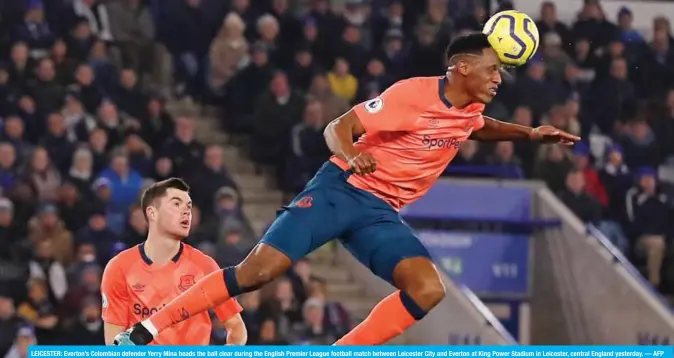  ?? — AFP ?? LEICESTER: Everton’s Colombian defender Yerry Mina heads the ball clear during the English Premier League football match between Leicester City and Everton at King Power Stadium in Leicester, central England yesterday.