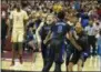  ?? MARK WALLHEISER - THE ASSOCIATED PRESS ?? Duke guard Jordan Goldwire, right, forward RJ Barrett, center, and forward Jack White rush the court to celebrate with Cam Reddish after Reddish scored the game-winning jump shot against Florida State on Saturday.