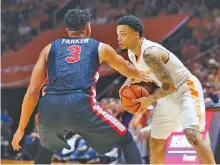  ?? THE ASSOCIATED PRESS ?? Tennessee’s Lamonte Turner is guarded by Georgia’s Juwan Parker during Saturday’s game in Knoxville. Turner scored nine points, all of them in crucial moments, as the Vols won 66-61 to earn a share of the SEC regular-season title. They’ll play in the...