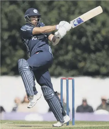  ??  ?? 0 Scotland captain Kyle Coetzer smashes the ball away while batting against Afghanista­n.