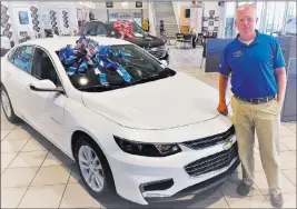  ??  ?? Findlay Chevrolet Findlay Chevrolet veteran sales consultant Matt Masluk is seen with a 2017 Chevrolet Malibu at the dealership in the southwest valley.