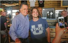  ?? Rick Bowmer / Associated Press ?? Mitt Romney joins supporters during a campaign stop at a barbecue restaurant Tuesday in South Jordan, Utah.