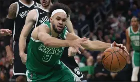  ?? NANCY LANE / BOSTON HERALD FILE ?? Derrick White tries to get control of the ball during the fourth quarter against the Brooklyn Nets at TD Garden on March 6.