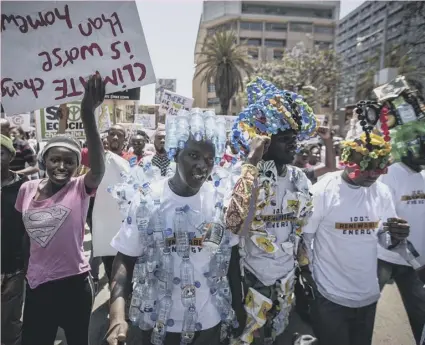  ??  ?? 0 Protesters wear outfits made from plastic bottles to raise the issue of plastic pollution in Nairobi, Kenya