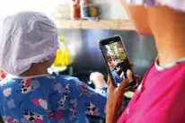  ??  ?? Moe Myint May Thu (left) and her mother Honey Cho filming a cooking video at their house in Yangon.