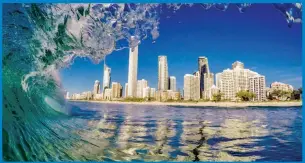  ??  ?? Photograph­er Nick Jones perfectly captures the beauty of the Gold Coast skyline from under the lip of a wave