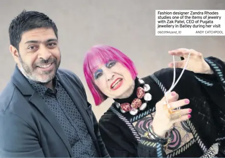  ??  ?? Fashion designer Zandra Rhodes studies one of the items of jewelry with Zak Patel, CEO of Pugata jewellery in Batley during her visitANDY CATCHPOOL