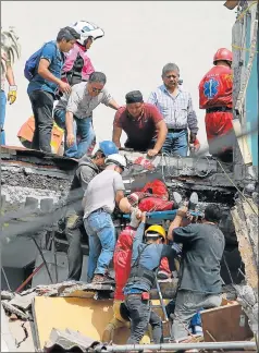  ?? Picture: GETTY IMAGES ?? DEVASTATIO­N: Rescuers and residents assist an injured victim amid the ruins of a building knocked down by a magnitude 7.1 earthquake that jolted central Mexico damaging buildings, knocking out power and causing alarm throughout the capital on Tuesday...