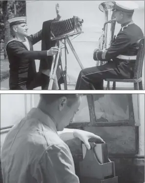  ?? PICTURES: FOX PHOTOS/GETTY IMAGES. ?? HOLD IT THERE: Top, a naval photograph­er, circa 1936, taking the picture of a fellow sailor playing the tuba, during preparatio­ns for Navy Week in Portsmouth; above, a photograph­ic technician placing glass negatives in a developing solution inside a darkroom at the Fox photo library circa 1935.