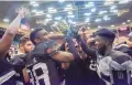  ?? ROBERTO E. ROSALES/JOURNAL ?? The Duke City Gladiators celebrate and pass the CIF Bowl trophy around after winning the championsh­ip for the second straight time last year. This year they are in a new league.