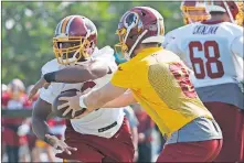  ?? [AP PHOTO/STEVE HELBER] ?? Former Oklahoma star Adrian Peterson, left, was the NFL's eighth-best rusher in his first season with Washington.