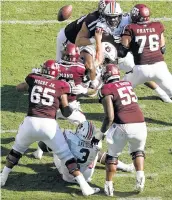  ?? Sam Craft / Associated Press ?? Texas A&M quarterbac­k Kellen Mond (11) fumbles after being hit by Auburn’s Derrick Brown.