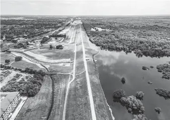  ?? Mark Mulligan / Staff file photo ?? Water flows through the new outlet control channel from Barker Reservoir on June 22 in Houston. Metro Houston’s list of public works projects has grown with its population.